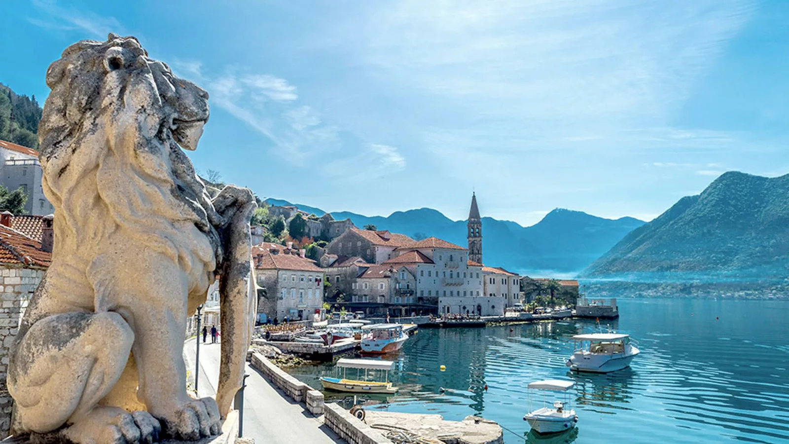 Lion statue in Kotor, Montenegro, showcasing intricate details and historical significance in a scenic urban setting.